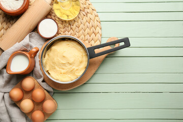 Ingredients for preparing churros on color wooden background