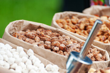 Assorted nuts in paper boxes for sale in the market.