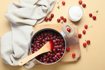 Preparing of tasty cherry jam on color background