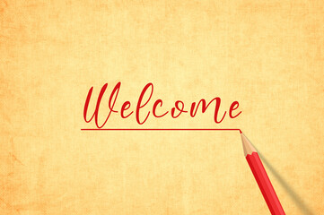 Welcome handwritten on yellow old paper with red pencil. 