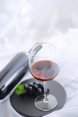 Glass with grape red semi-dry wine. Valentine's day concept background. Gift for the holiday. Sweet sparkling wine.