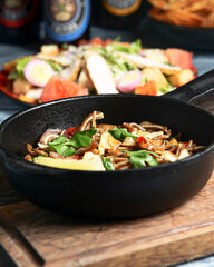 Fried pig ears with sesame seeds and green onions close-up. Fried pig ears in korean style.