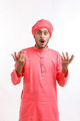 Young indian farmer in traditional wear and giving shocking expression.