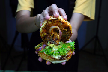 Chef holding a beef burger