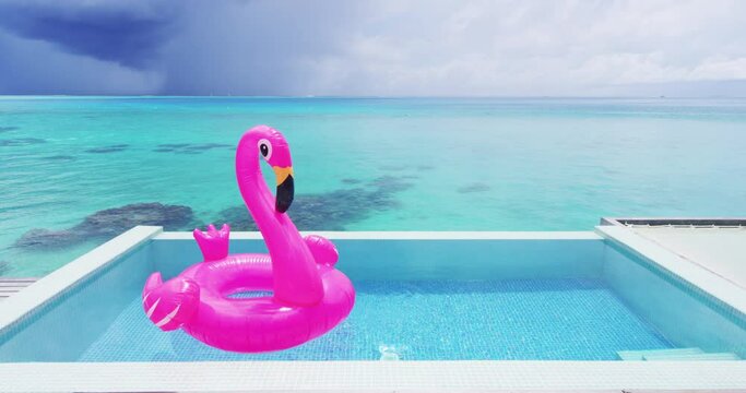Vacation Travel Pool Beach travel concept with inflatable pink flamingo float toy mattress in luxury swimming pool. Lifestyle summer holidays travel concept perfect background video. Slow motion