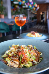 Asian wok stir fry served in a plate over dark wooden table. Asian cuisine concept, traditional recipe.