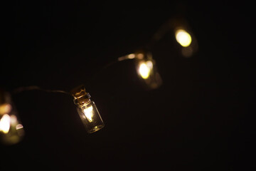 Christmas garland of glass bottles. New year and christmas concept. A garland of light bulbs with a beautiful light and bokeh