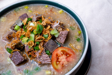 Coto Makasar, Indonesian Traditional Food, beef soup cooked with rice washing water and mashed fried peanut and spices