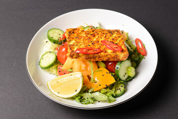 Grilled chicken sandwich and fresh vegetable salad on a plate, lunch or breakfast. Healthy eating concept.