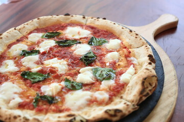 Italian traditional Margherita pizza cooked in a oven.