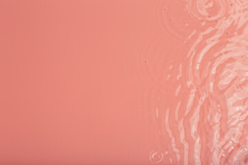 Water tranquil ripple background. Water texture, circles and bubbles on a liquid pink surface. Cosmetic products and flat design concept