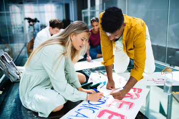 University students activists making banners for protest indoors, fighting for free education concept.