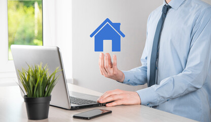 Real estate concept, businessman holding a house icon.House on Hand.Property insurance and security...