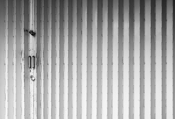 Locked classic folding metal gate of old shop