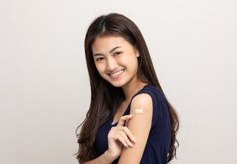 Vaccination. Young beautiful asian woman getting a vaccine protection the coronavirus. Smiling...