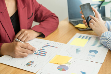 Two business leaders talk about charts, financial graphs showing results are analyzing and calculating planning strategies, business success building processes