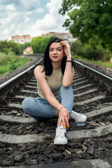 Beautiful lady posing near the railway track, summer time