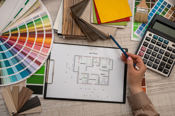 hand selects a color from the palette on architectural plan