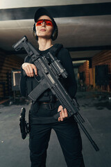 Cute young shooter with a firearm looking ahead