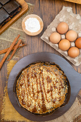 Kue Hok Lo Pan or martabak bangka. The martabak bangka batter is made from a mixture of flour, eggs, sugar, baking soda, coconut milk and water.The batter is cooked upon a thick round iron frying pan 
