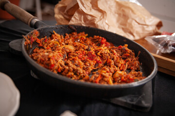 dinner in a pan with rice, paprika and vegetables