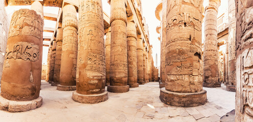 Karnak Temple columns with ancient carvings, Luxor, Egypt - obrazy, fototapety, plakaty