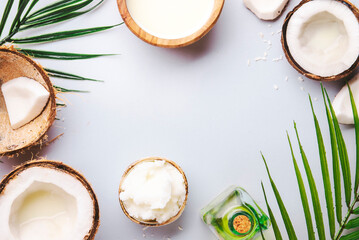 Natural Coconuts products - mct butter, oil, milk, shavings on gray background. Hair, skin and body treatment and healthy food. Top view