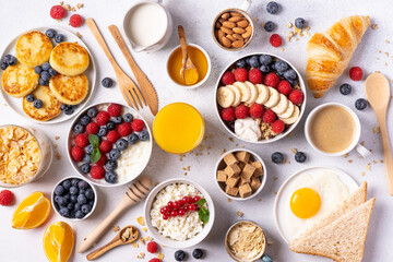 The continental breakfast is captured from above, top view. Coffee, croissants, granola, Belgian waffles, honey, jam. Layout with free text space, copy space
