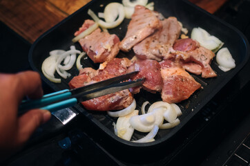 Meat grilling on the cooking pan