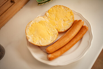 
sausages with a bun and butter for breakfast