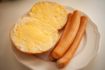 
sausages with a bun and butter for breakfast