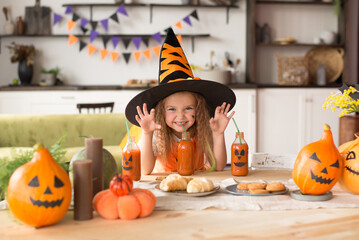 a child in a Halloween costume with a pumpkin is fooling around at the holiday 