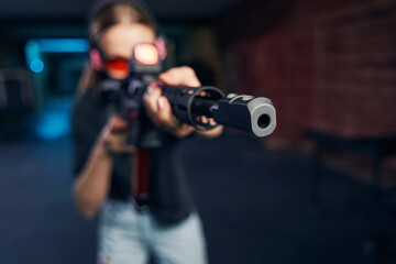Fototapeta na wymiar Caucasian sniper in safety goggles firing a weapon