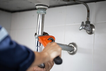 plumber at work in a bathroom, plumbing repair service, assemble and install concept.