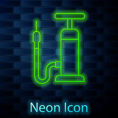 Glowing neon line Bicycle air pump icon isolated on brick wall background. Vector