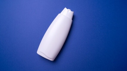 shampoo or hair conditioner bottle isolated on blue background