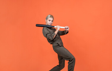 in motion. woman in boilersuit with bat. female baseball player. sports and games.