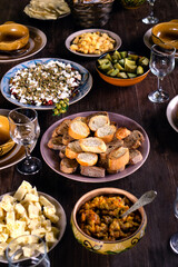 Salad with feta and sun-dried tomatoes, croutons and cheddar cheese on the table