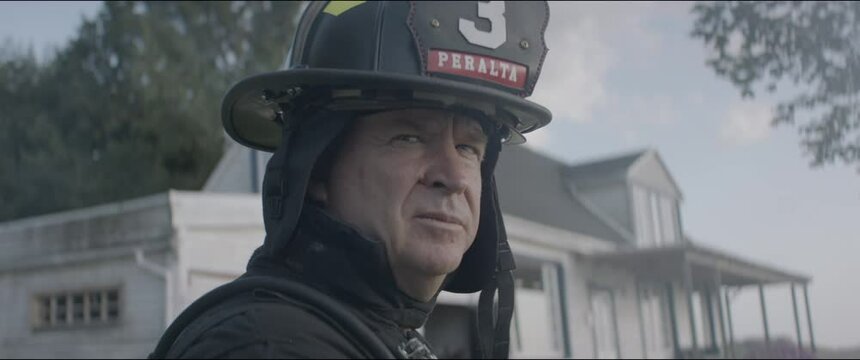 Portrait of firefighter chief looking into camera. Shot with 2x anamorphic lens