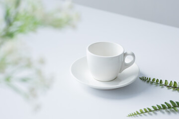 white coffee cup on a white table.