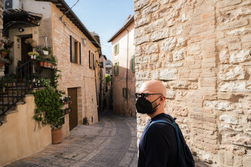 portrait of a person walking in the street with mask