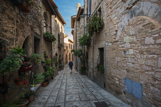 Fototapeta A young man walk along the beautiful streets of Spello, Umbria