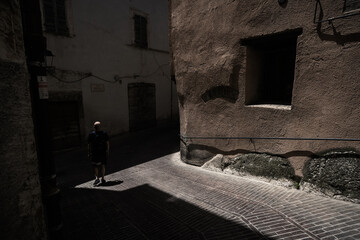 A young man walking along the streets of Trevi