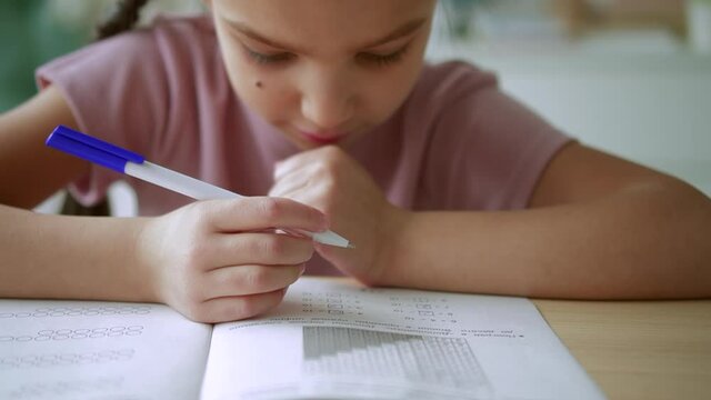Home education for children girl student does sums at table Spbd