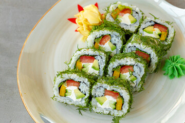 Vegeterian sushi roll with dill and vegetables on wooden background
