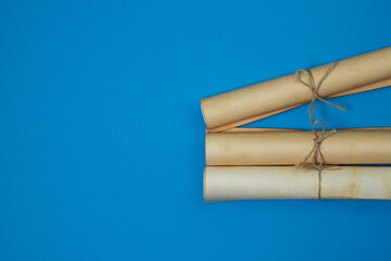 Old scrolls on a blue background. Knowledge and education concept. There is a place for an inscription or logo