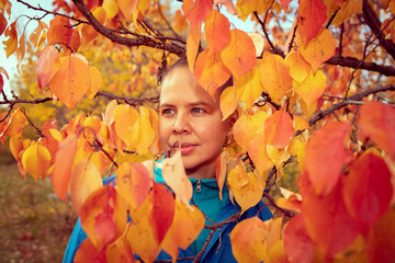portrait of a girl in red and yellow leaves