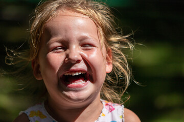 the child is crying and laughing, the child is hysterical