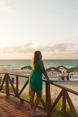 Girl walks along the beach in a dress