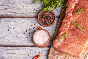 A piece of raw pork loin, marinated fresh meat with spices